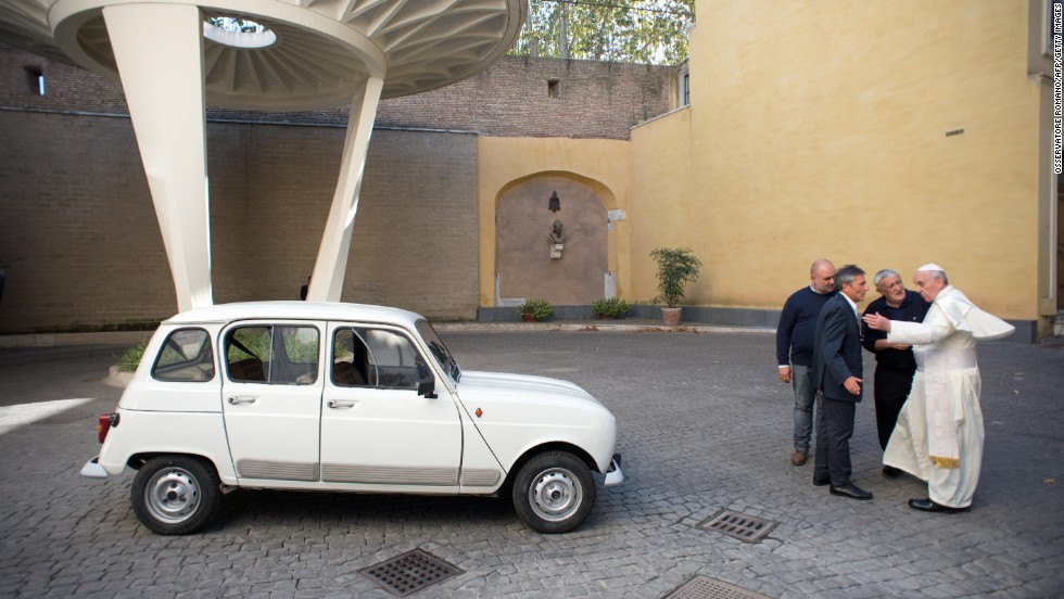 Francis has eschewed fancy cars. Here, Father Don Renzo Zocca, second from right, offers his white Renault 4L to the Pope during a meeting at the Vatican in September 2013.