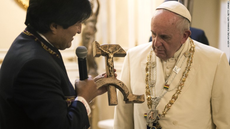 Bolivian President Evo Morales presents the Pope with a gift of a crucifix carved into a wooden hammer and sickle -- the Communist symbol uniting laborers and peasants -- in La Paz, Bolivia, on Wednesday, July 8.